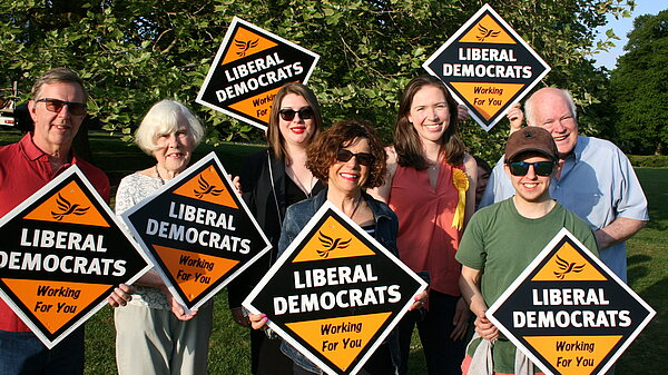 Group of Lib Dems holding sign boards